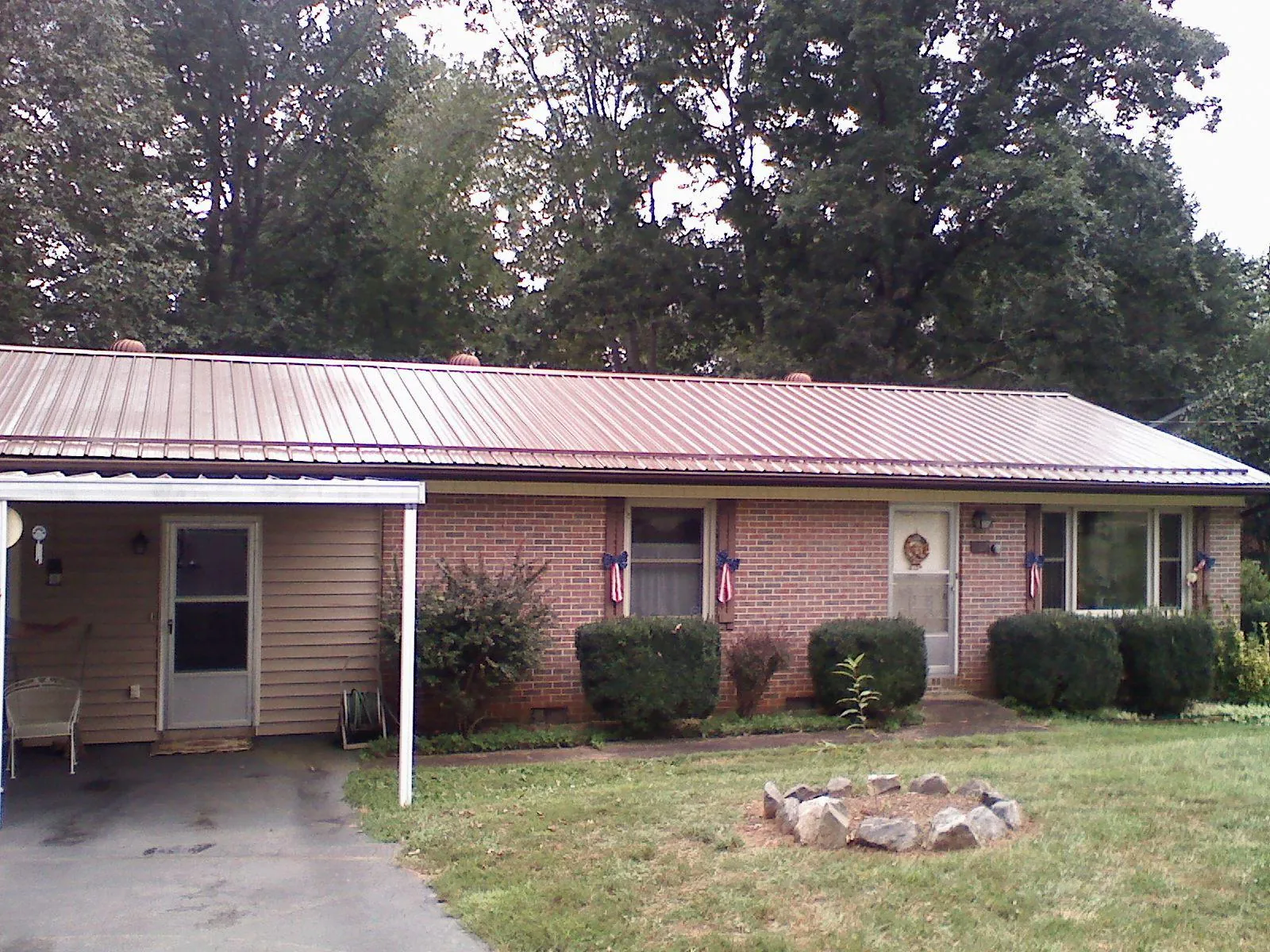 Bronze metal roof and carport on a brick ranch home — Roof Repair work by our crew in Red Lion