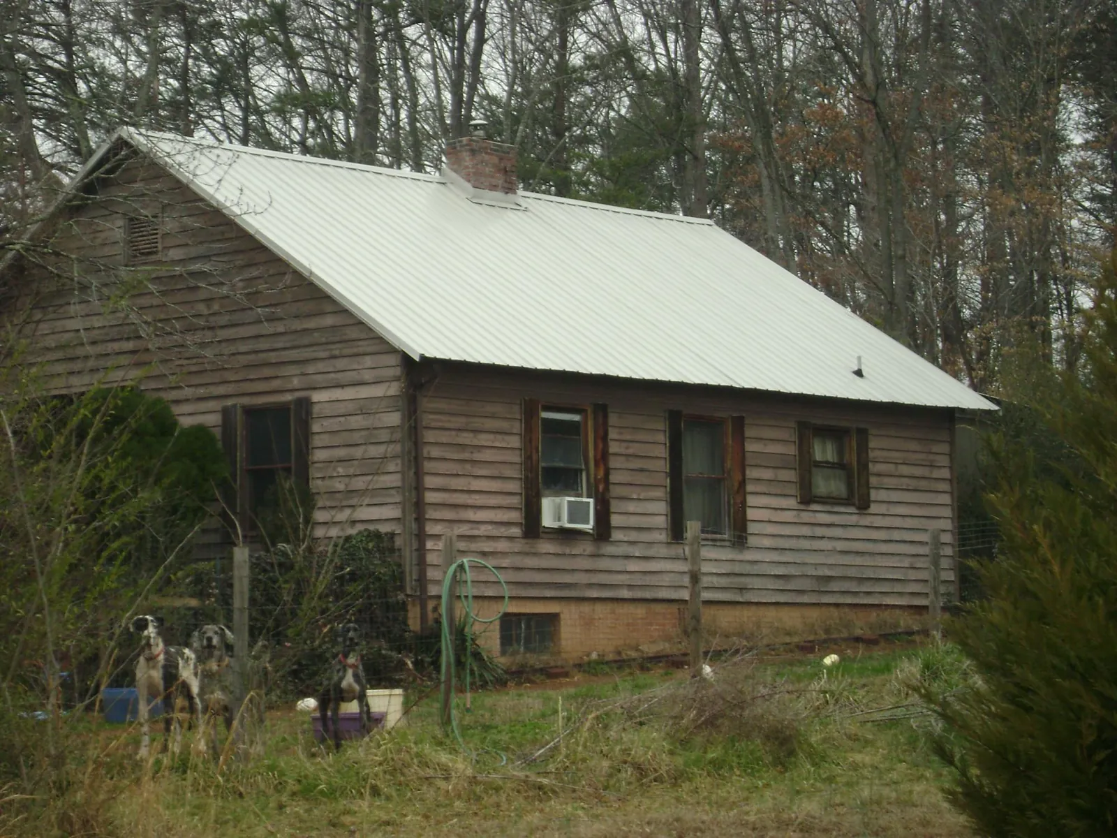 White metal roof on an old wood sided farmhouse, from a Metal Roof Installation job in Red Lion